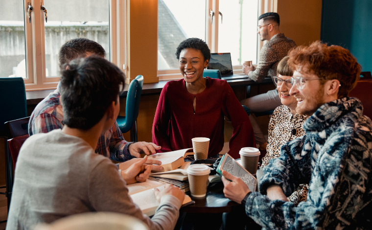 A group of readers sitting around a table in a coffee shop