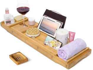 A bamboo bath tray with an iPad propped up in the center