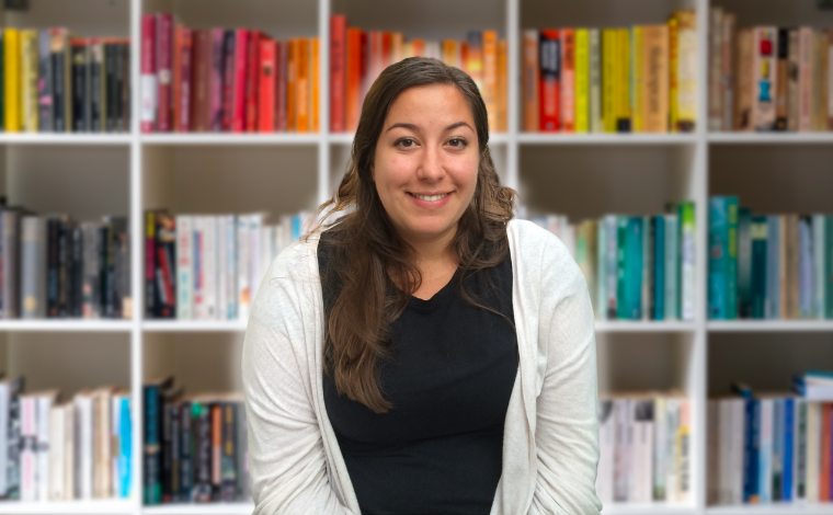 Photo of Amanda in front of a bookcase