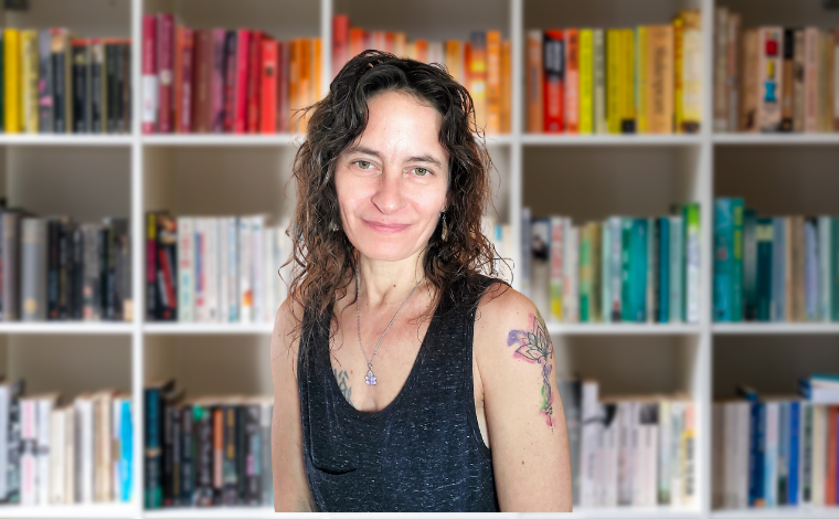 Photo of Alicia in front of a bookcase