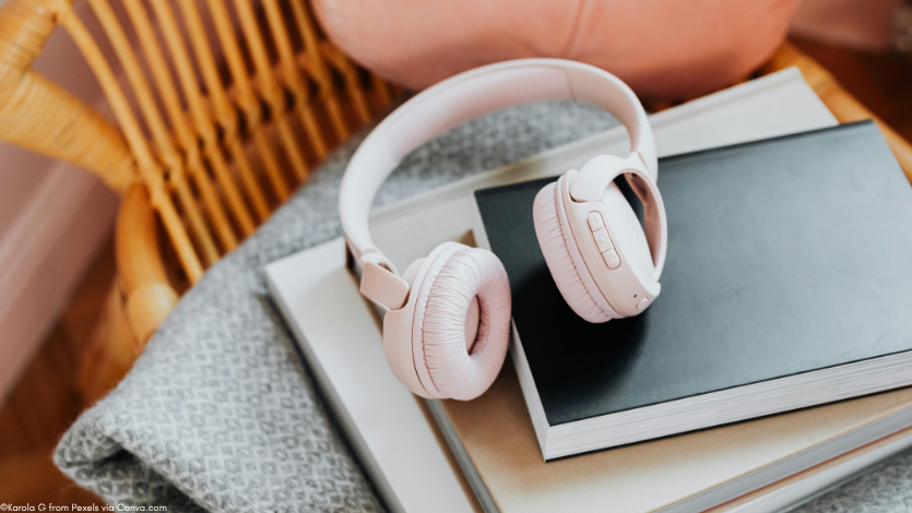 A pair of headphones on a bookstack