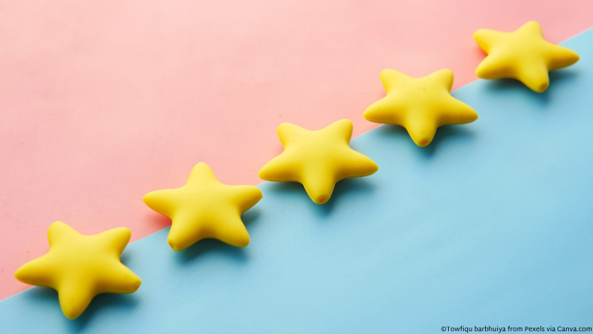 Five yellow stars across blue and pink paper