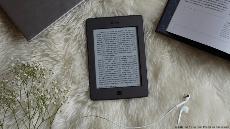 An e-reader on a faux fur throw blanket