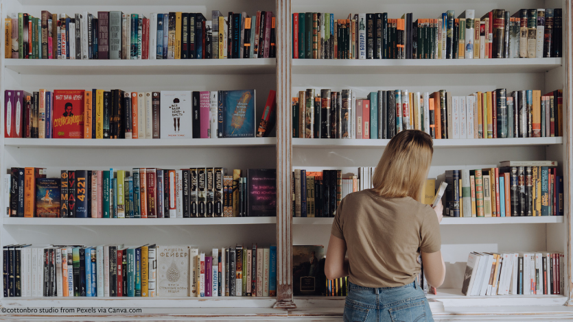 A woman looking at bookshelves