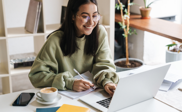 A girl smiling at her computer