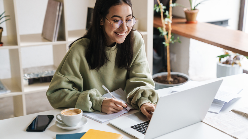 A girl smiling at her computer