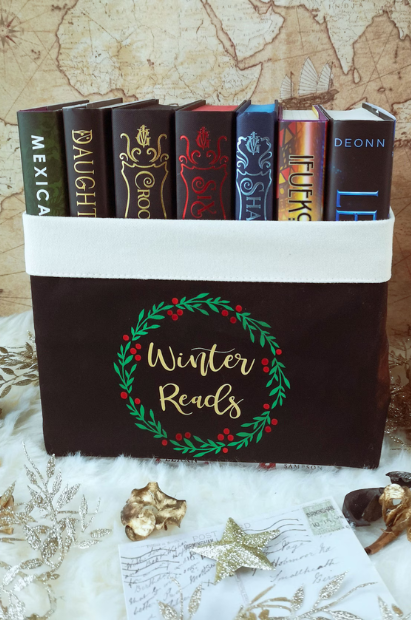 A black basket that says "winter reads"