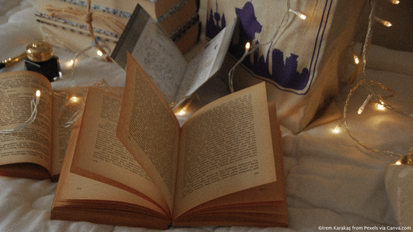 An open book with fairy lights above it