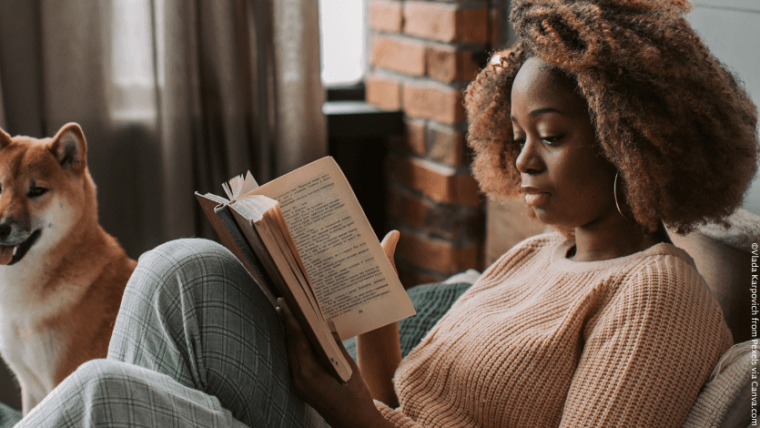 A Black woman reading a book