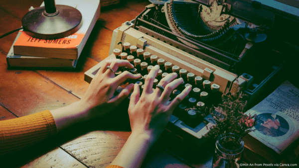 A set of hands working on a typewriter