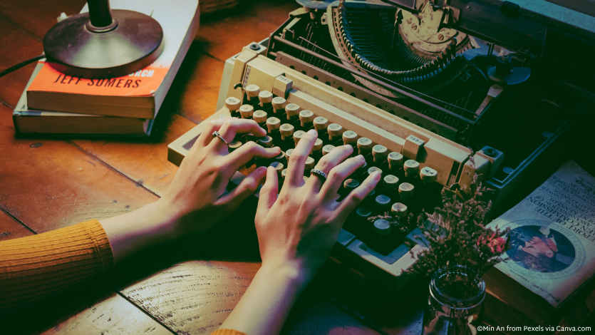 A set of hands working on a typewriter