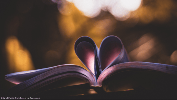 An open book with pages folded to make a heart
