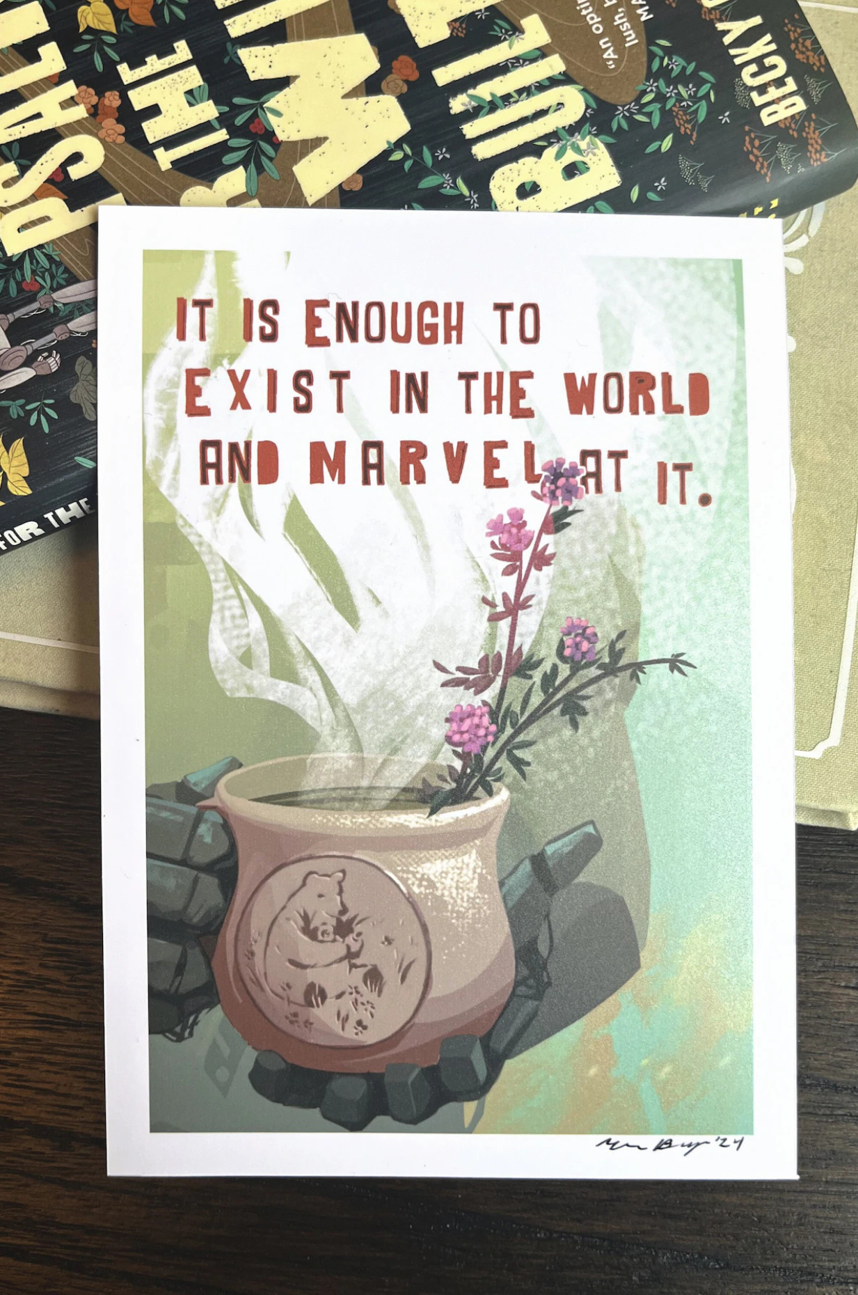 An art print of robot hands holding a steaming mug with a quote from Becky Chambers