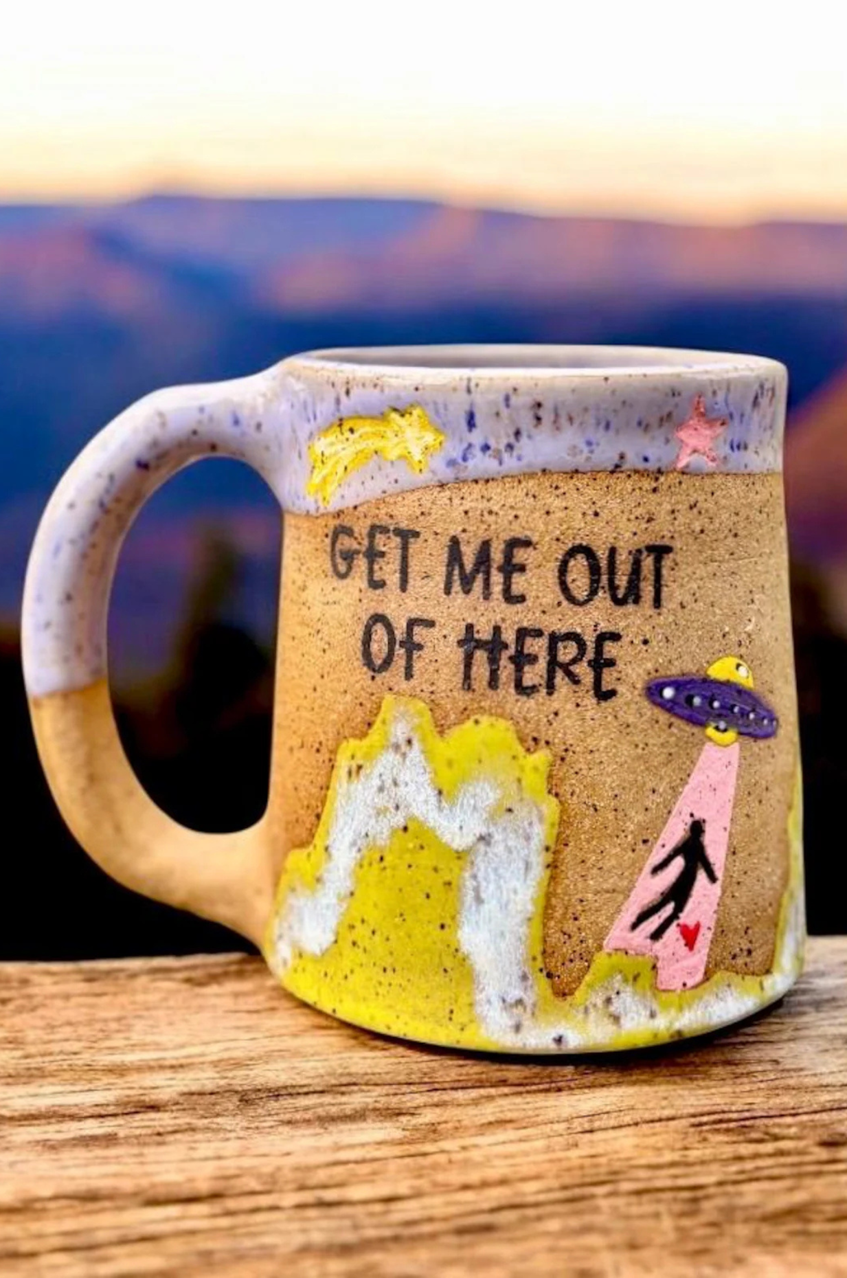 A mug portraying an alien abduction
