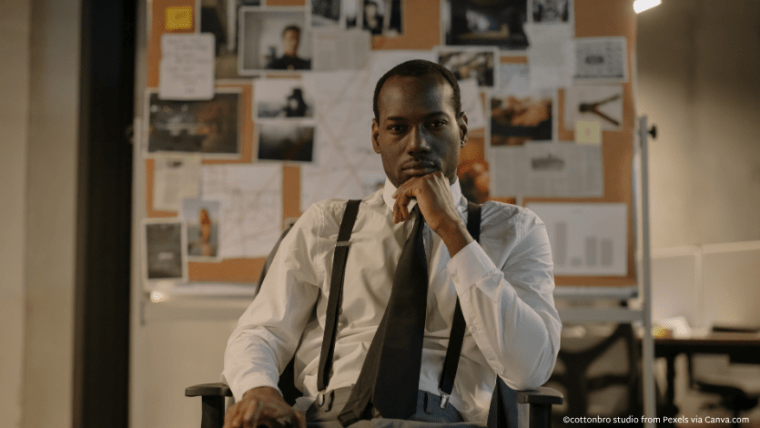 A detective sitting in front of a corkboard of clues