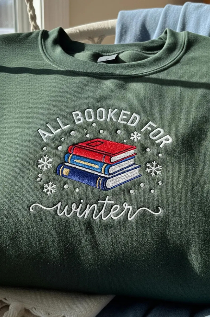 Sweatshirt that reads 'All Booked For Winter'