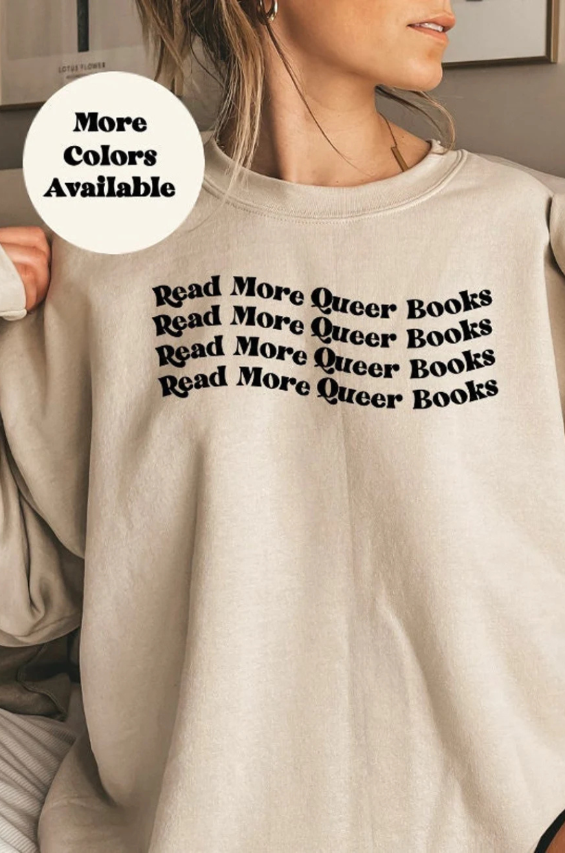Sweatshirt that reads 'Read More Queer Books'
