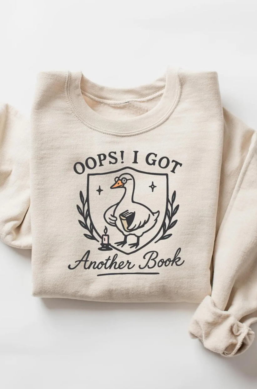 Sweatshirt that reads 'Oops! I got another book' with an image of a goose with a book