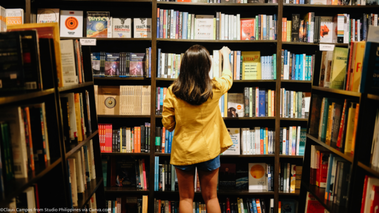 Woman reaching for book on shelf