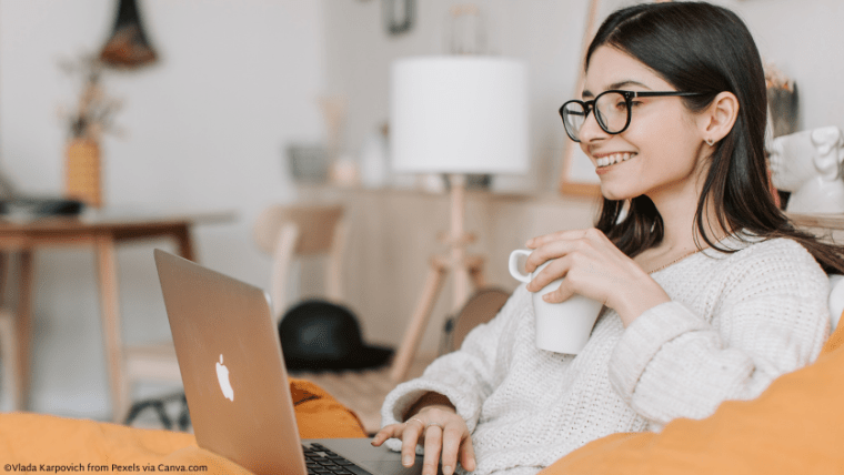 A woman smiling at her computer