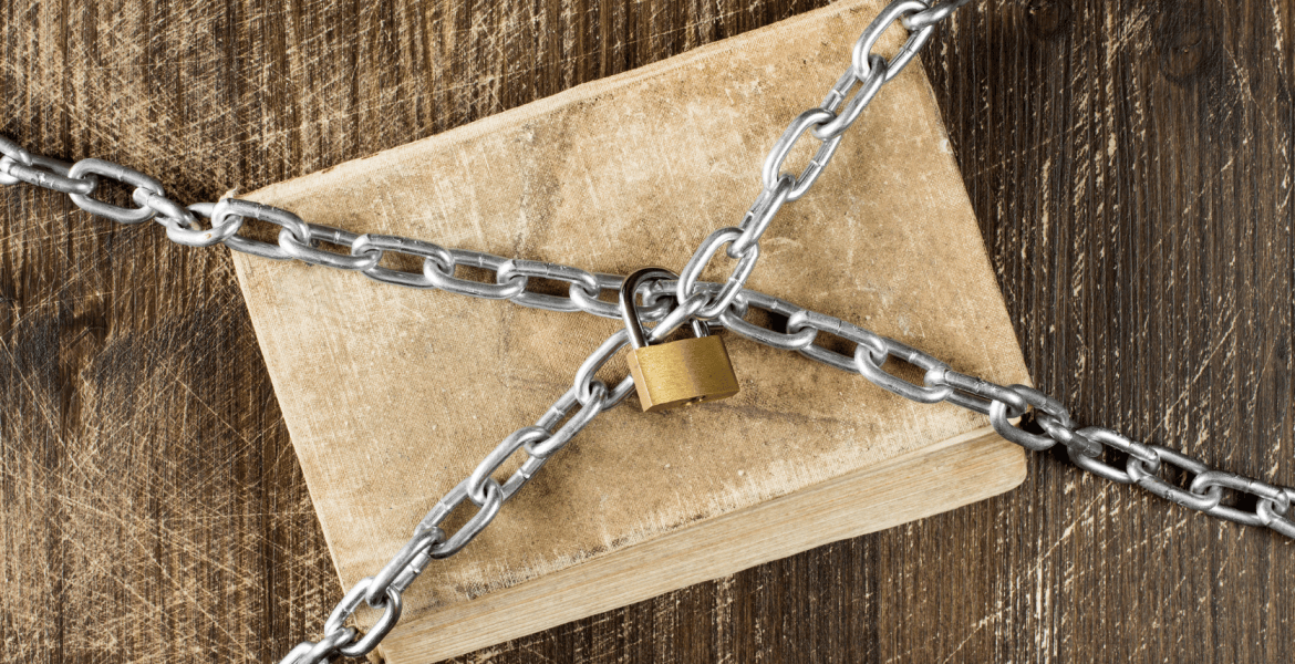 A book covered in chains locked with a gold lock