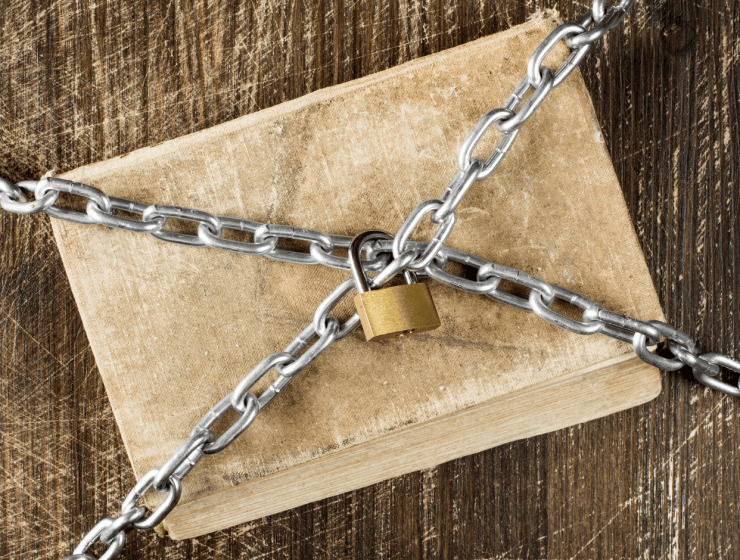 A book covered in chains locked with a gold lock
