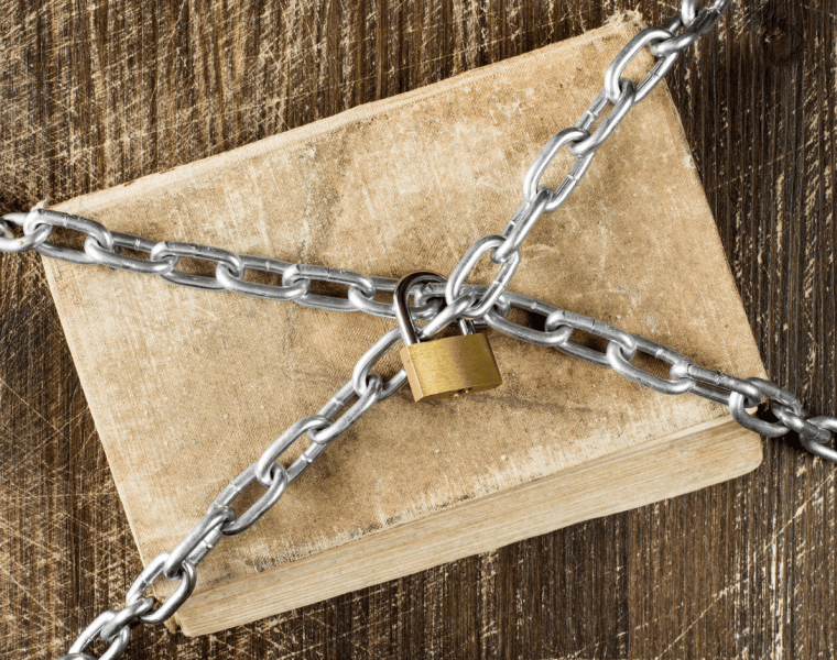 A book covered in chains locked with a gold lock