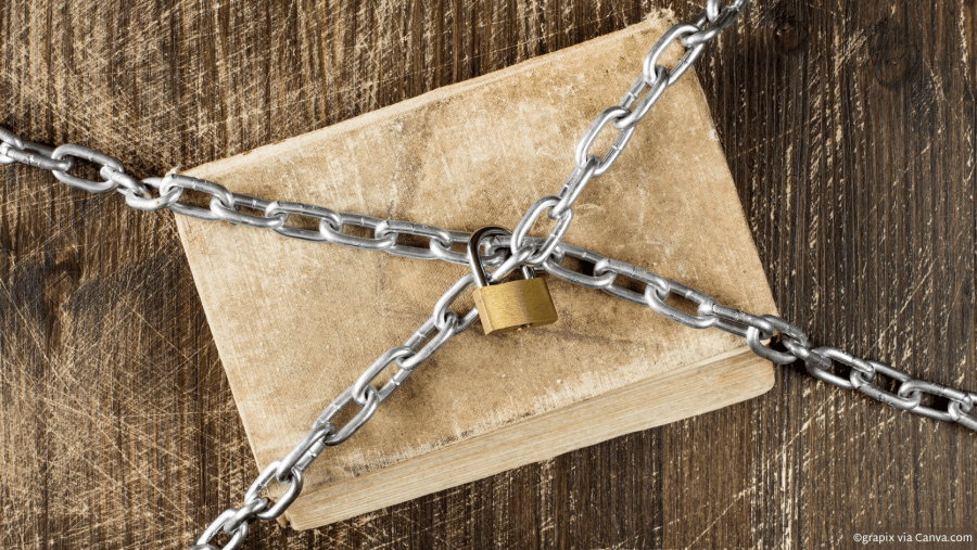 A book covered in chains locked with a gold lock